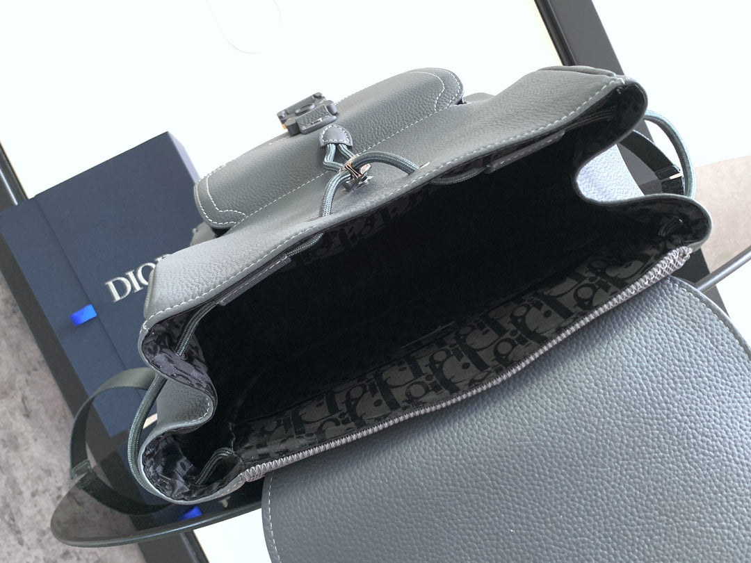 Gray leather backpack with open top and monogram fabric lining