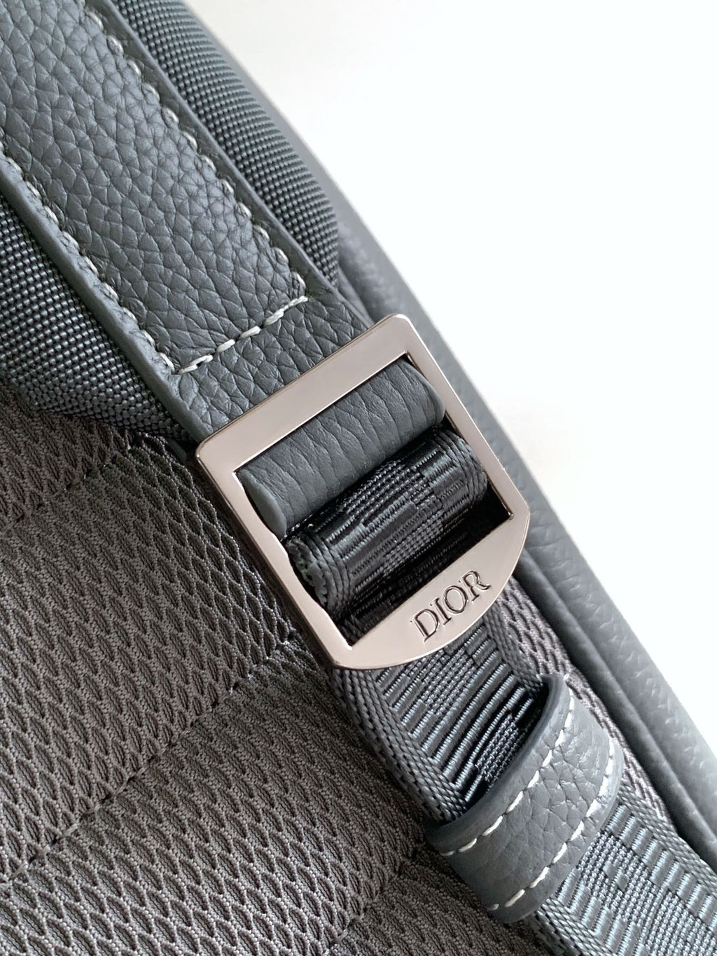 Gray leather strap with metal buckle and woven DIOR logo patch