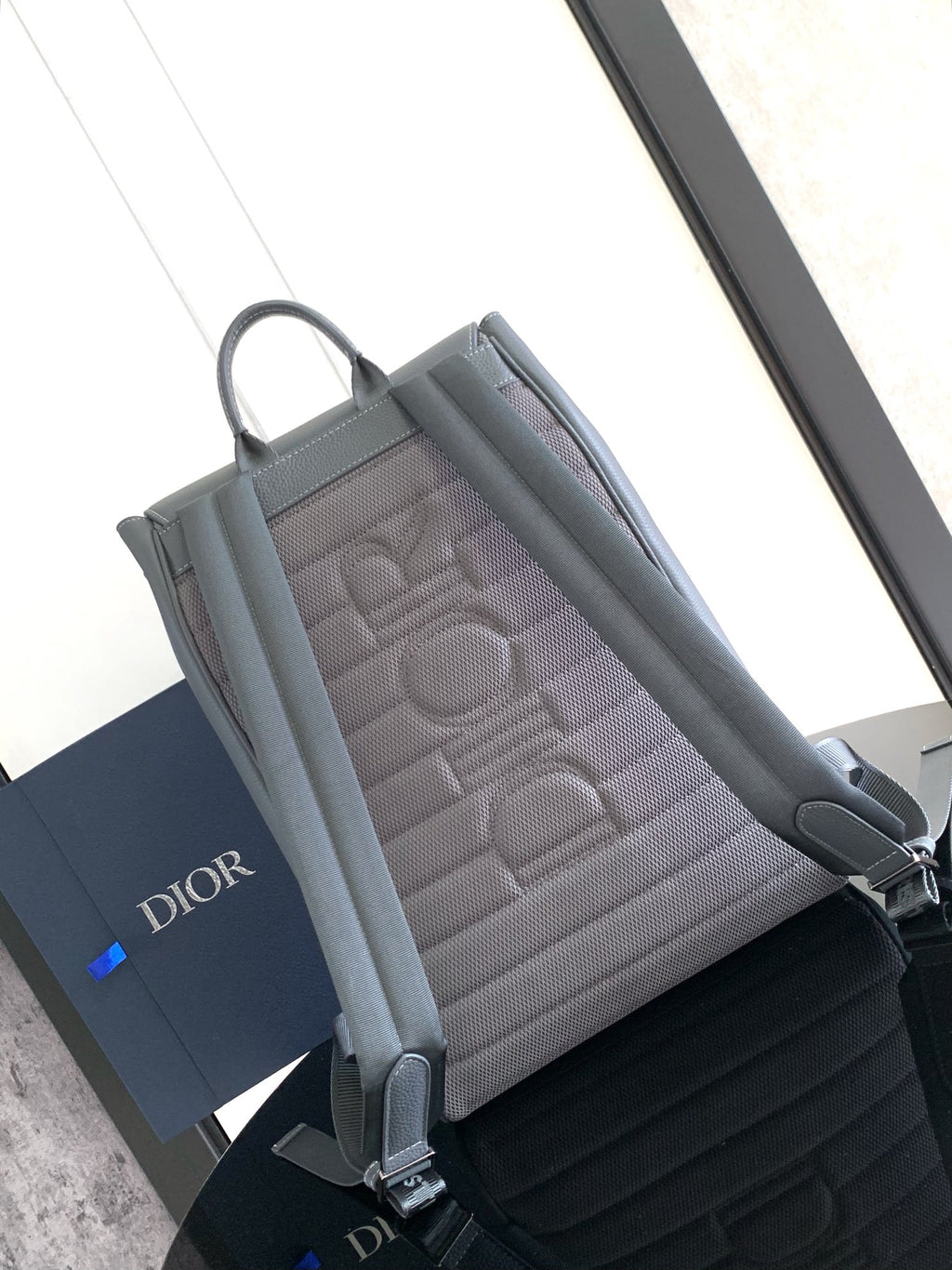 Men's gray backpack with quilted interior panel and front flap pocket