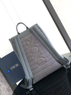 Men's gray backpack with quilted interior panel and front flap pocket