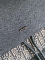 Gray leather Dior logo label stitched along the edge of the bag