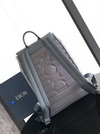 Light gray Dior shoulder bag back panel with quilted texture and straps