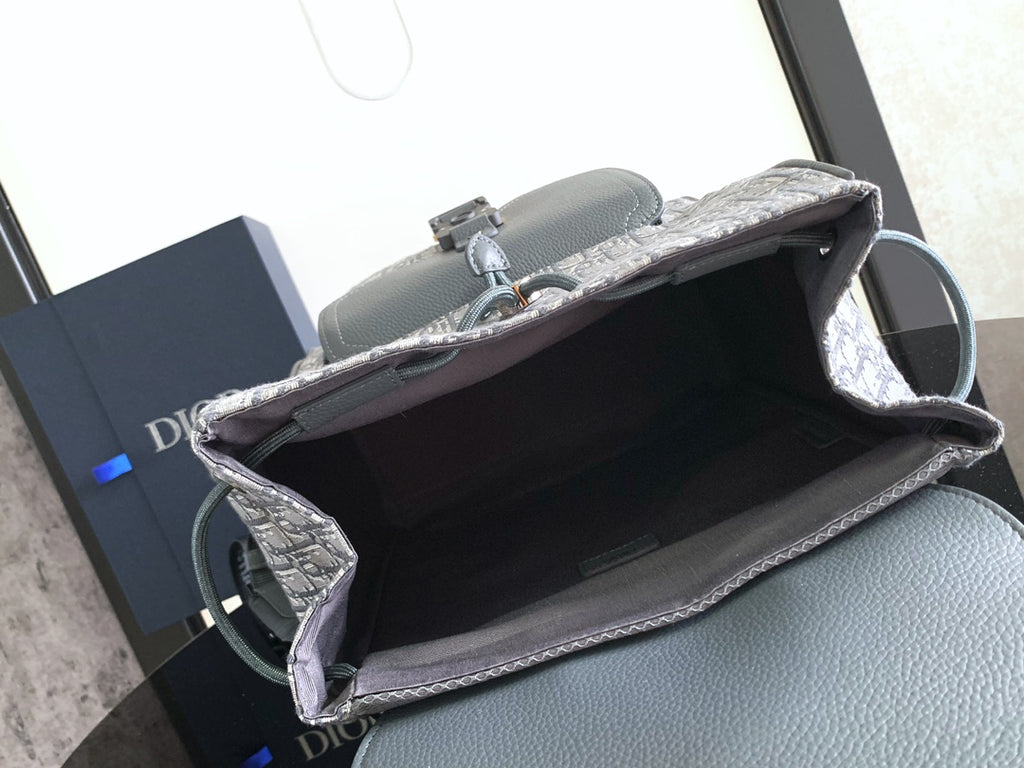 Dior bag open top view with gray leather interior and Dior Oblique exterior