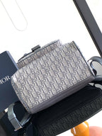 Dior bag with Dior Oblique print front and gray leather top handle and strap