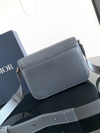 Blue-gray leather flap bag with contrast interior and adjustable strap