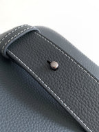 Dior bag front button detail with contrast white stitching