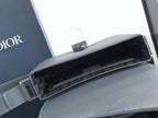 Dior open flap bag showing dark interior lining with hardware on blue-gray leather