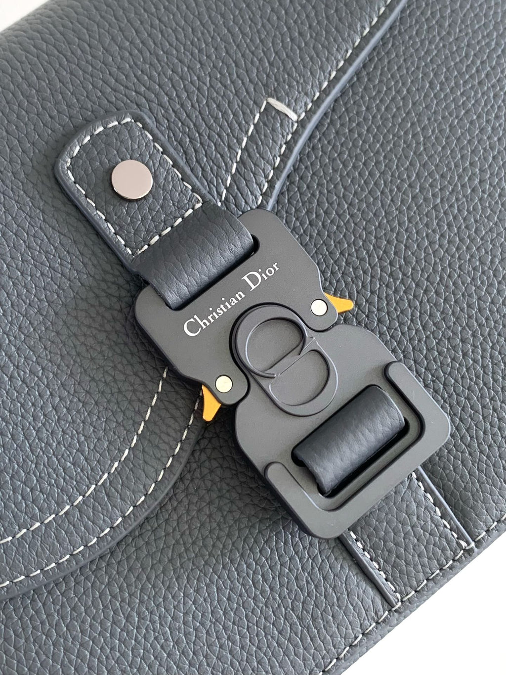 Blue-gray leather key holder with Christian Dior branding and metal clasp