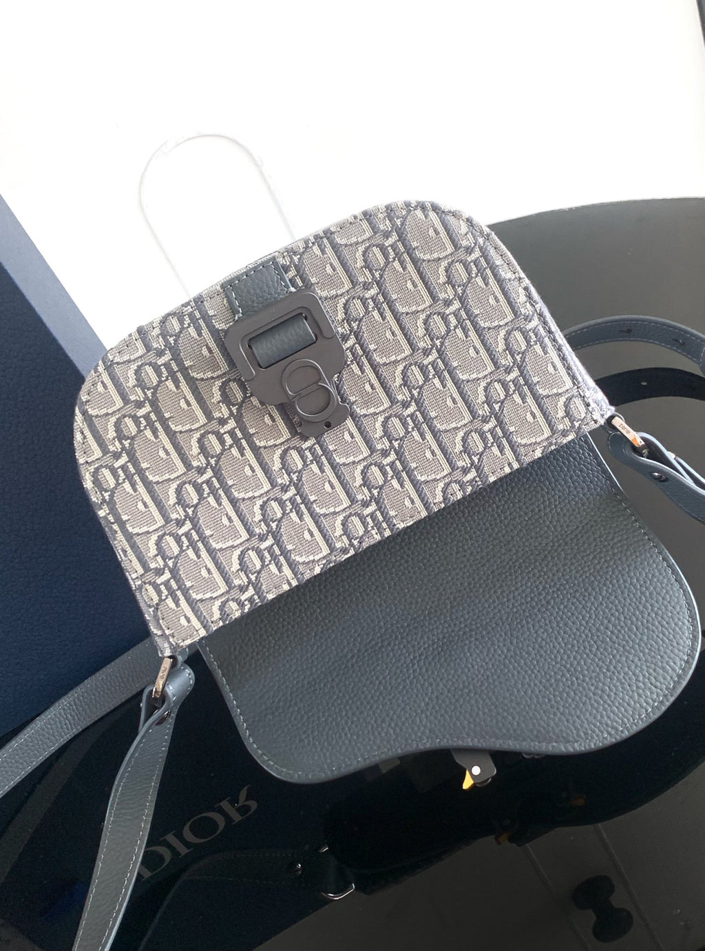 Dior bag with monogram canvas front panel and gray leather top flap