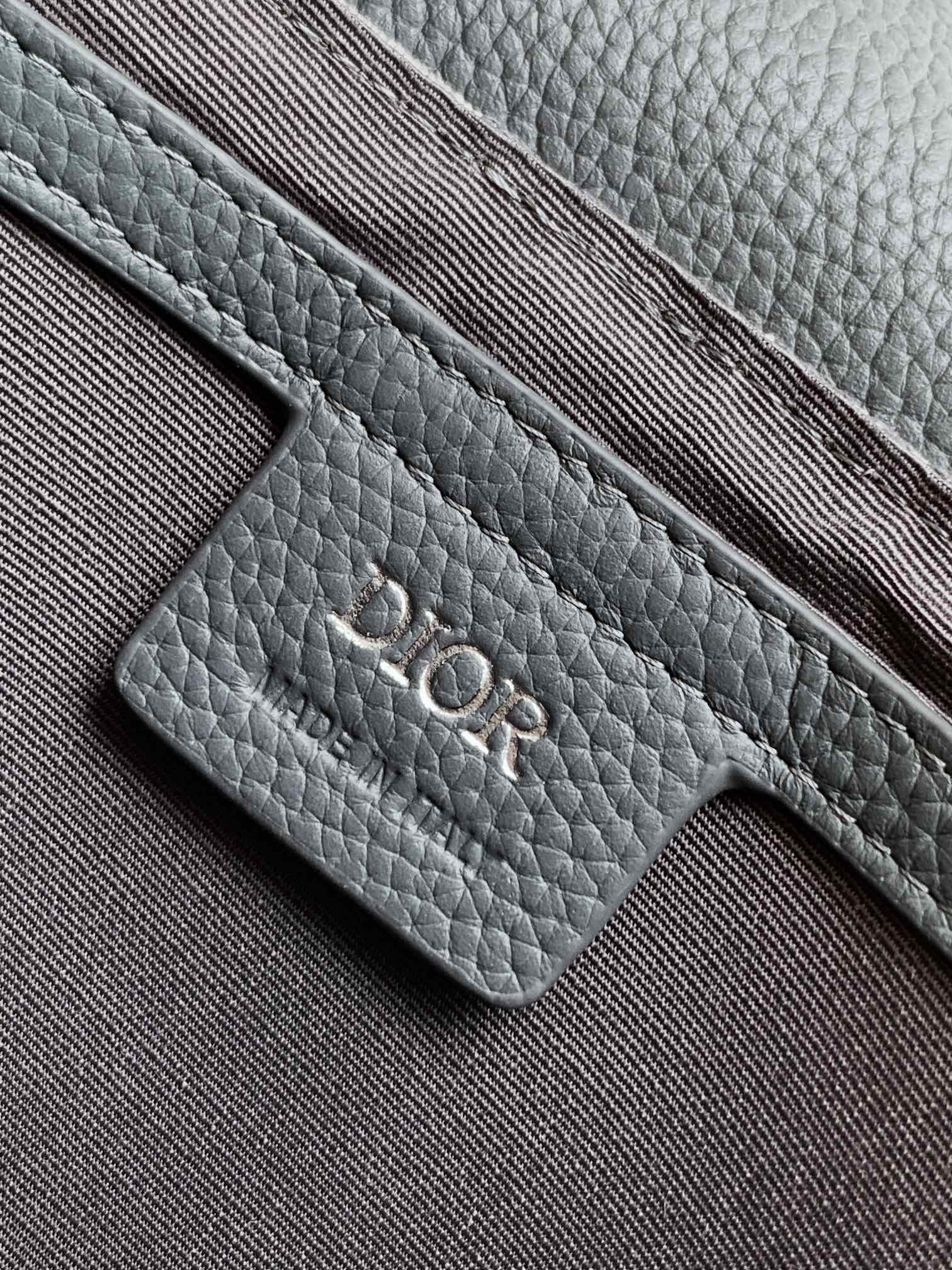 Blue-gray leather strap tab with stitched edge and Dior engraved logo
