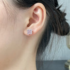 Four-leaf clover stud earring with pink enamel on the ear