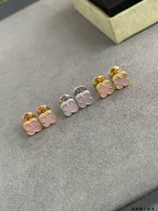 Four-leaf clover stud earrings in mixed gold, silver, and pink enamel colors