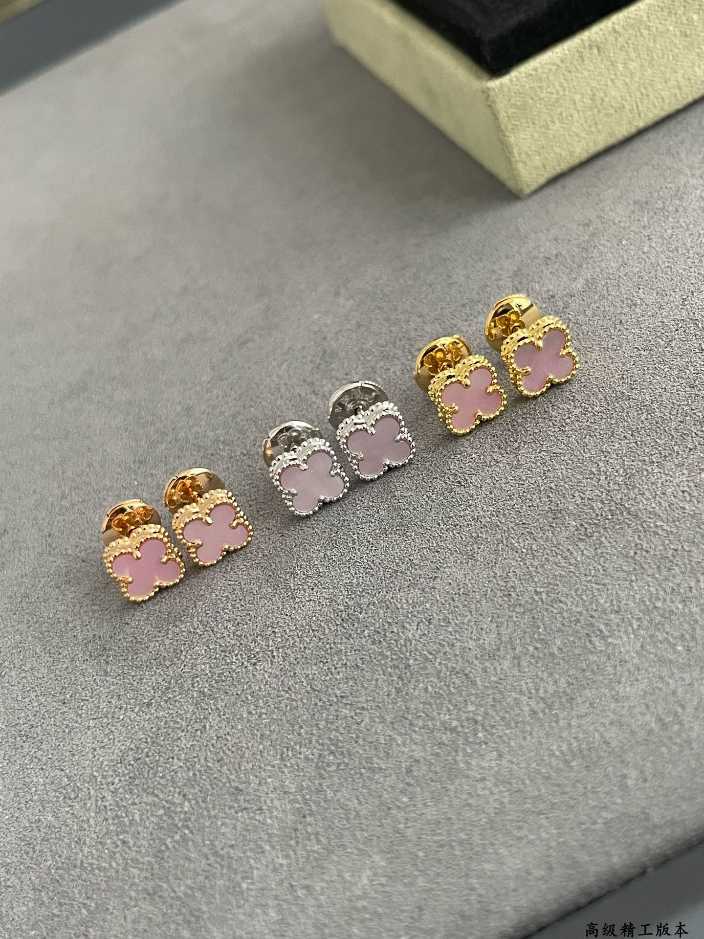 Four-leaf clover stud earrings in mixed gold, silver, and pink enamel colors
