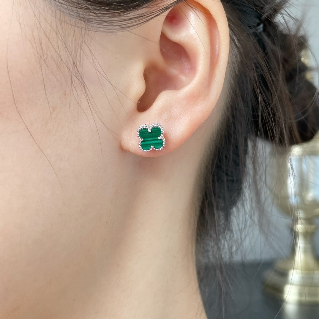 Van Cleef & Arpels clover stud earring with green enamel on ear