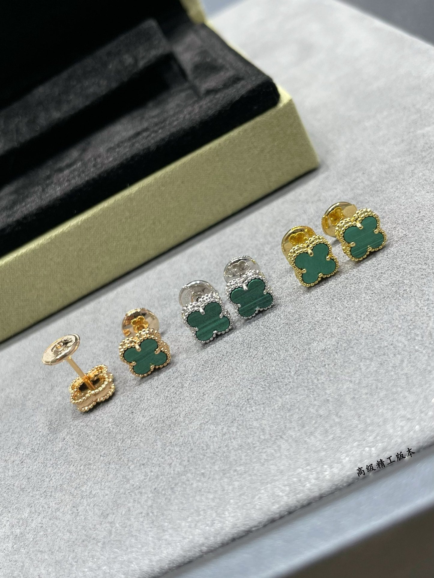 Van Cleef & Arpels clover stud earrings with green enamel, gold and silver tones