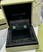 Van Cleef & Arpels clover stud earrings on black velvet inside gift box, green enamel