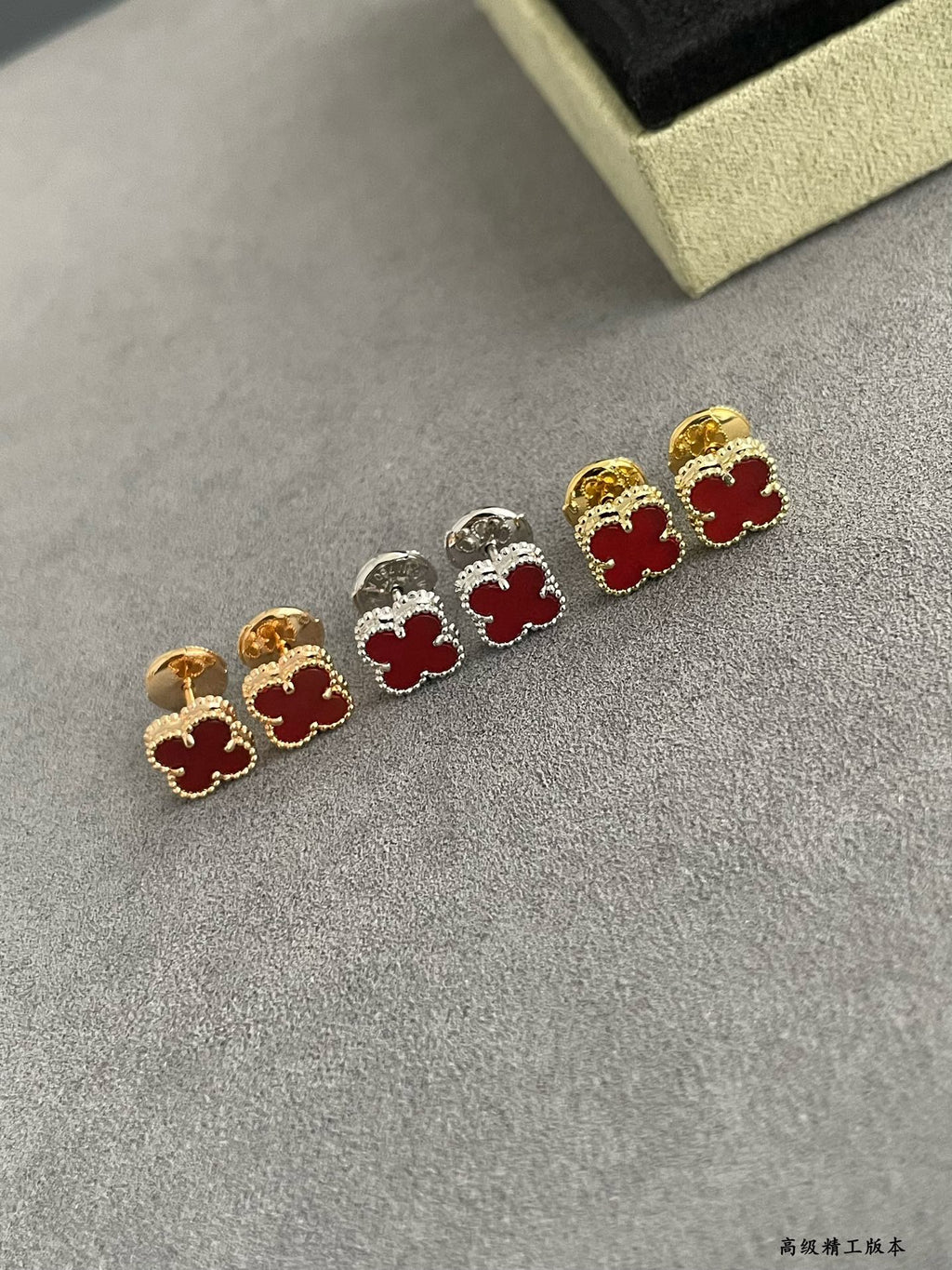 Clover stud earrings with gold and silver frames and red enamel flower centers