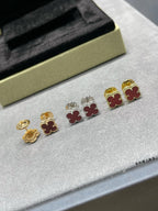Clover motif stud earrings set, with gold, silver, and red enamel accents