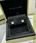 Gold-tone clover stud earrings in black velvet presentation box