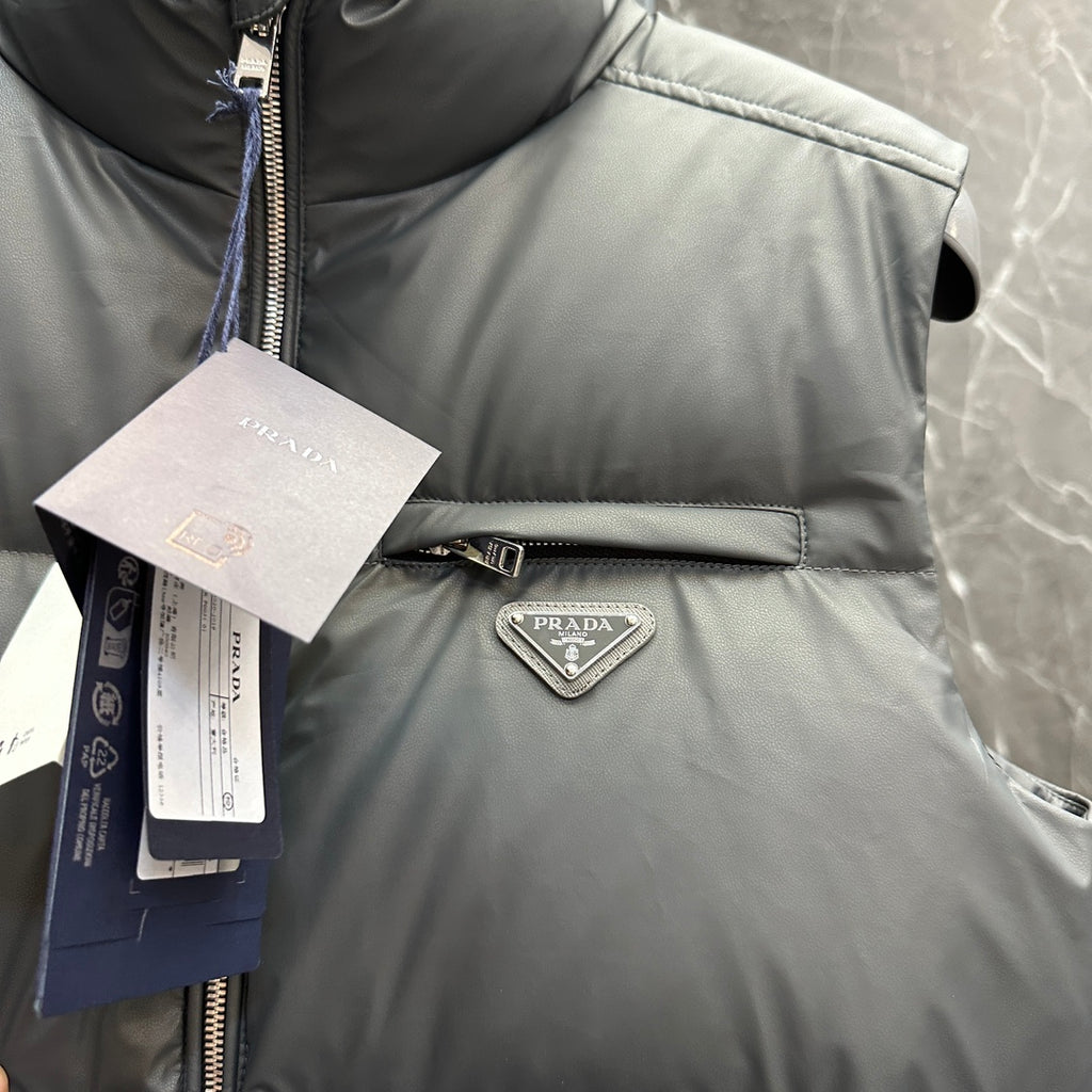 Light gray puffer vest chest detail with Prada triangle logo and zipper placket