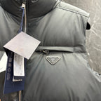 Light gray puffer vest chest detail with Prada triangle logo and zipper placket