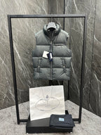 Light gray puffer vest on hanger with hooded collar, front zipper, and Prada logo