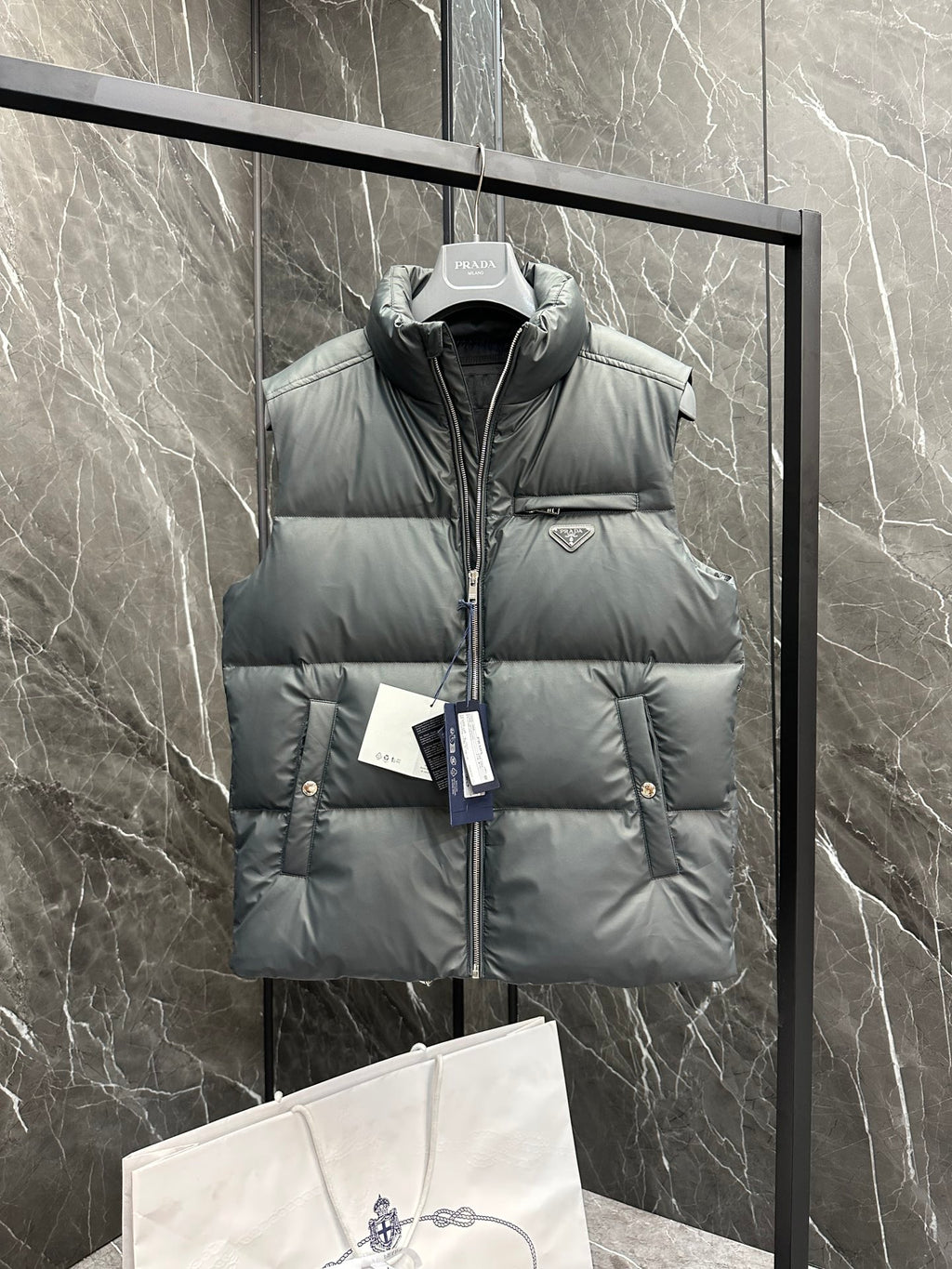 Light gray puffer vest with full front zipper and hood, Prada triangle logo on chest