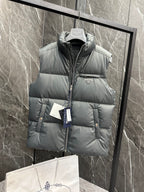 Light gray puffer vest with hooded neck, quilted panels, and Prada logo badge