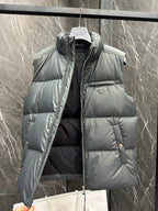 Light gray quilted puffer vest with front zipper, side pockets, and Prada triangle badge
