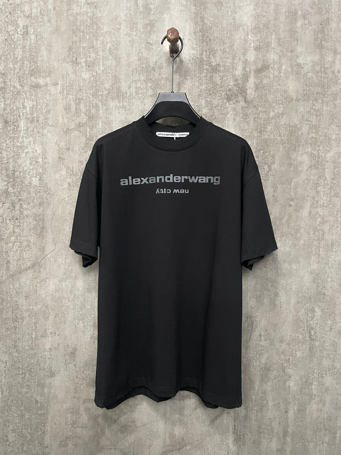 Black short-sleeve T-shirt with front crew neck and chest logo print