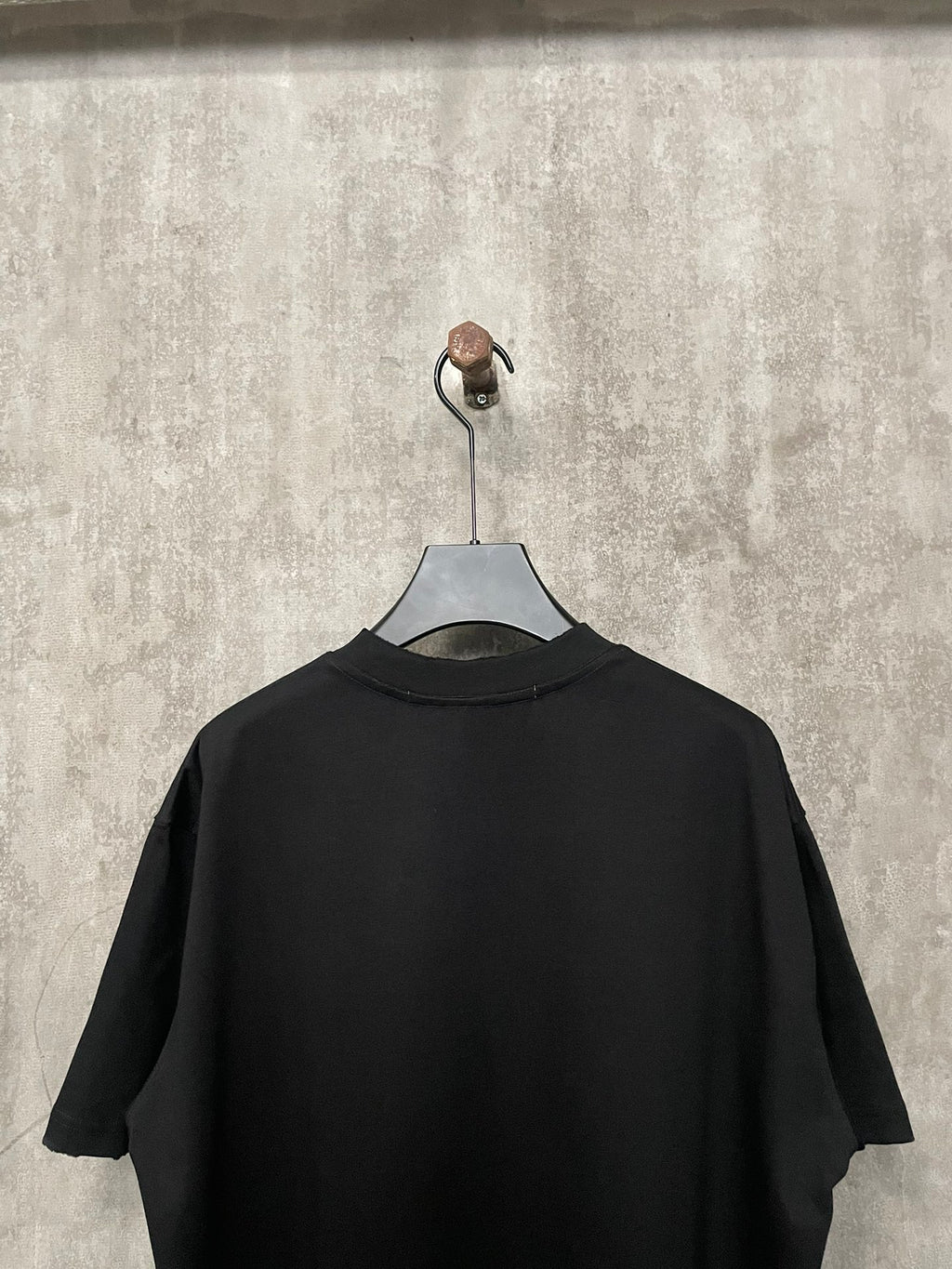 Black short-sleeve T-shirt back view on hanger