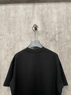 Black short-sleeve T-shirt back view on hanger