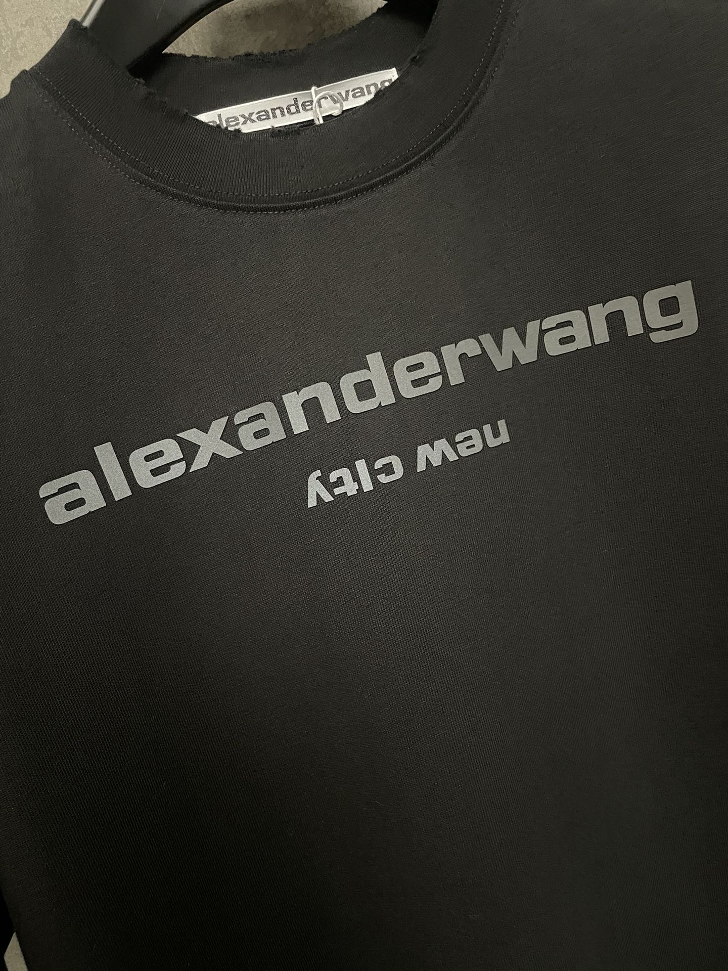 Black T-shirt logo print on chest with crew neck collar