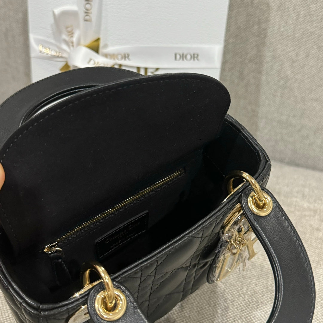Black Dior quilted handbag interior with zipper pocket and gold-tone zipper pull