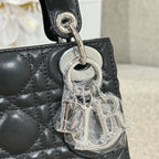 Black quilted leather Dior handbag charm with silver CD logo on key fob.