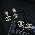 Chanel accessory: pearl and crystal CC drop earrings with gold-tone charms