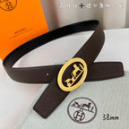Brown leather belt with gold oval buckle on a diagonal angle