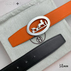 Hermes belt set, orange leather with silver oval logo buckle and black strap with punched holes