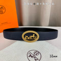 Hermes leather belt with navy strap and gold oval horse buckle