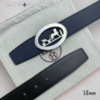 Leather belt with navy strap and silver oval horse buckle, close-up
