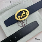 Leather belt with navy strap and gold oval horse buckle, close-up