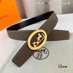 Hermes leather belt with taupe strap and gold oval buckle, black belt nearby