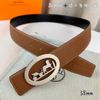 Brown leather belt with silver oval horse-motif buckle, 38mm width.