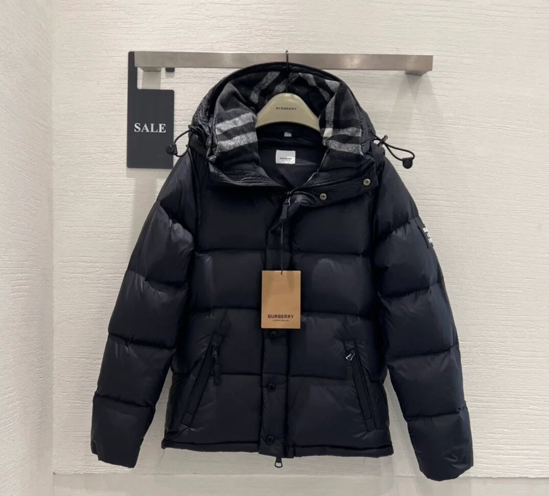 Burberry puffer jacket with dark insulated shell, plaid hood, drawstring waist and zipper