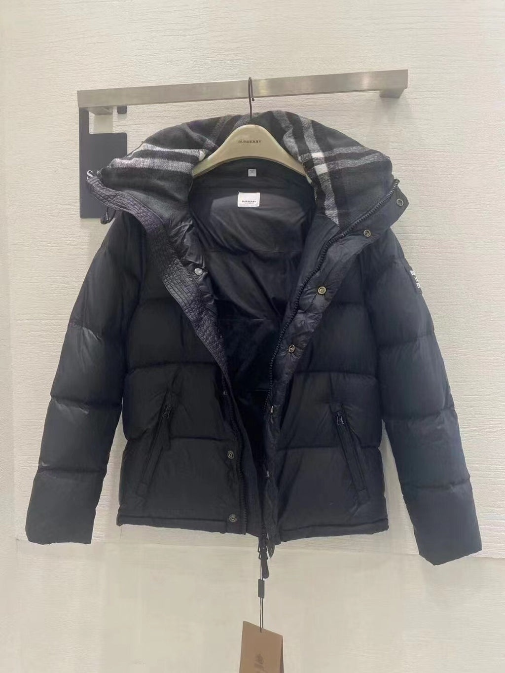 Burberry puffer jacket rear view with plaid hood lining and dark quilted insulation