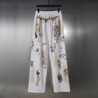 White wide-leg pants with black graphic print and elastic waistband