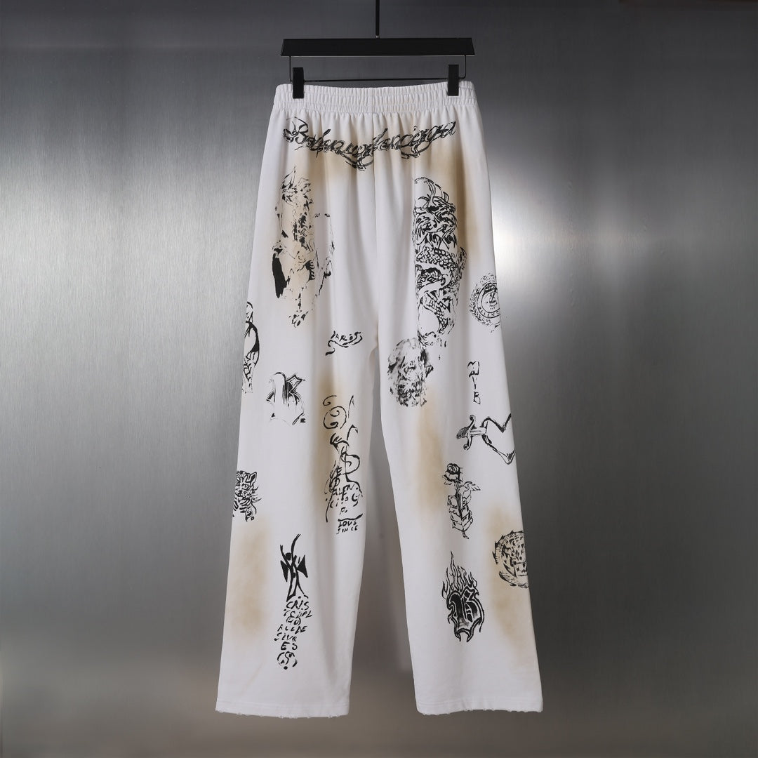 White wide-leg pants with black graphic print and elastic waistband