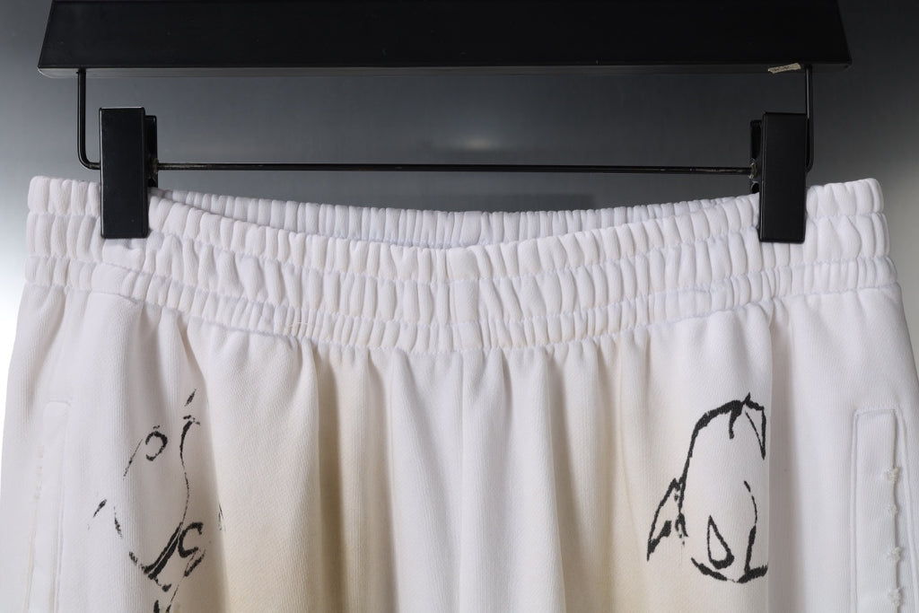White elastic waistband pants with black graphic motif at front