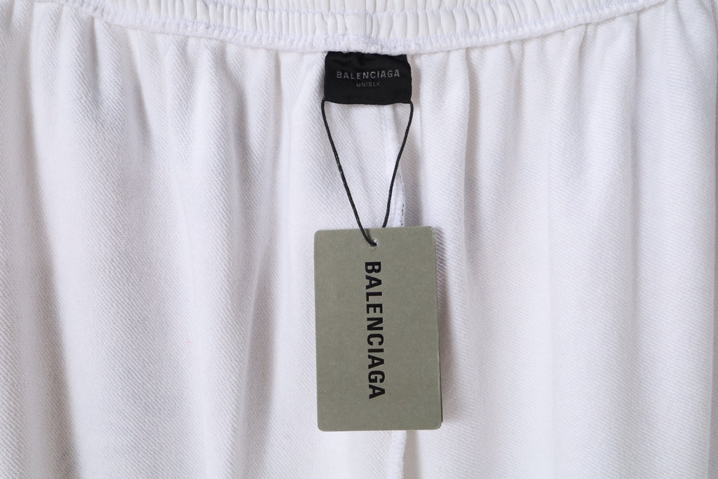White pants with Balenciaga logo label at the waistband