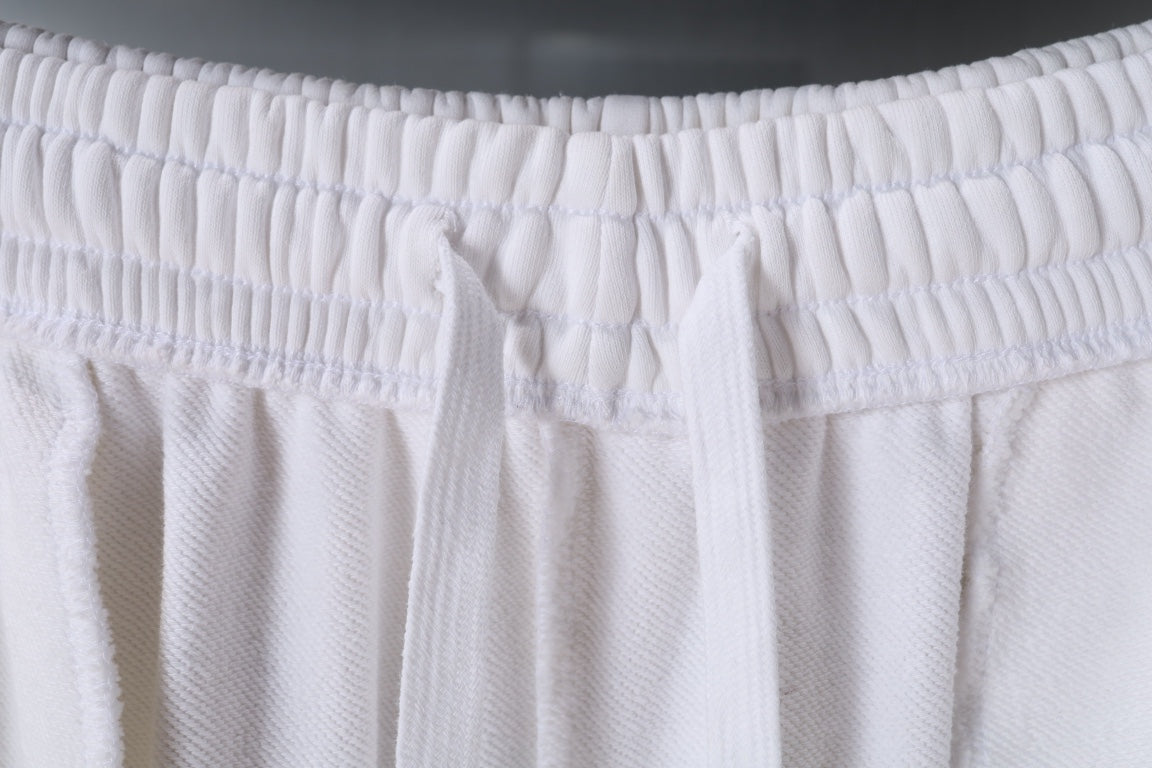 White pants with elastic waistband and front pleats
